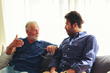 Older Plano homeowner talking with adult child about downsizing and staying socially connected