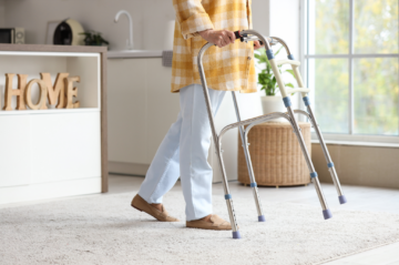 Older McKinney homeowner comfortably walking through a bright single-story North Texas home designed for aging in place