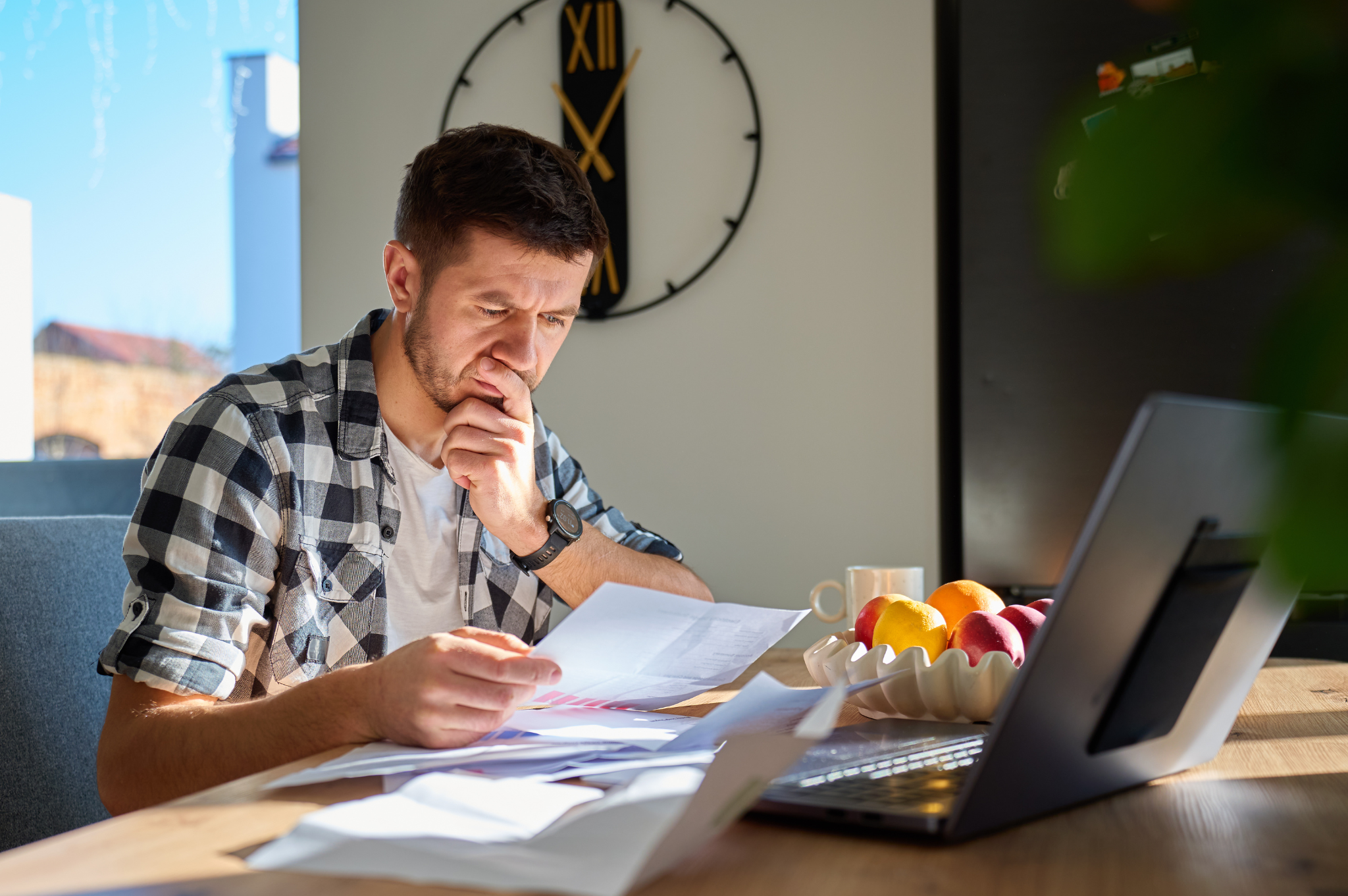 Frisco homeowner reviewing a property tax statement and home value information at a kitchen table