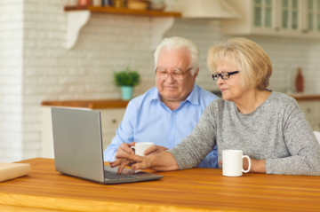 Plano senior couple comparing home, rightsizing and senior living options at a kitchen table