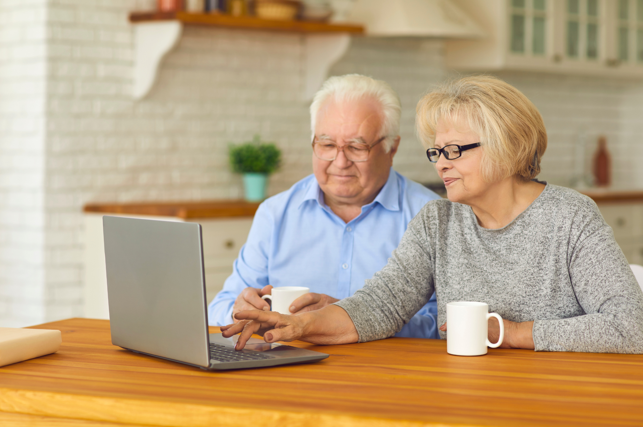 Plano senior couple comparing home, rightsizing and senior living options at a kitchen table